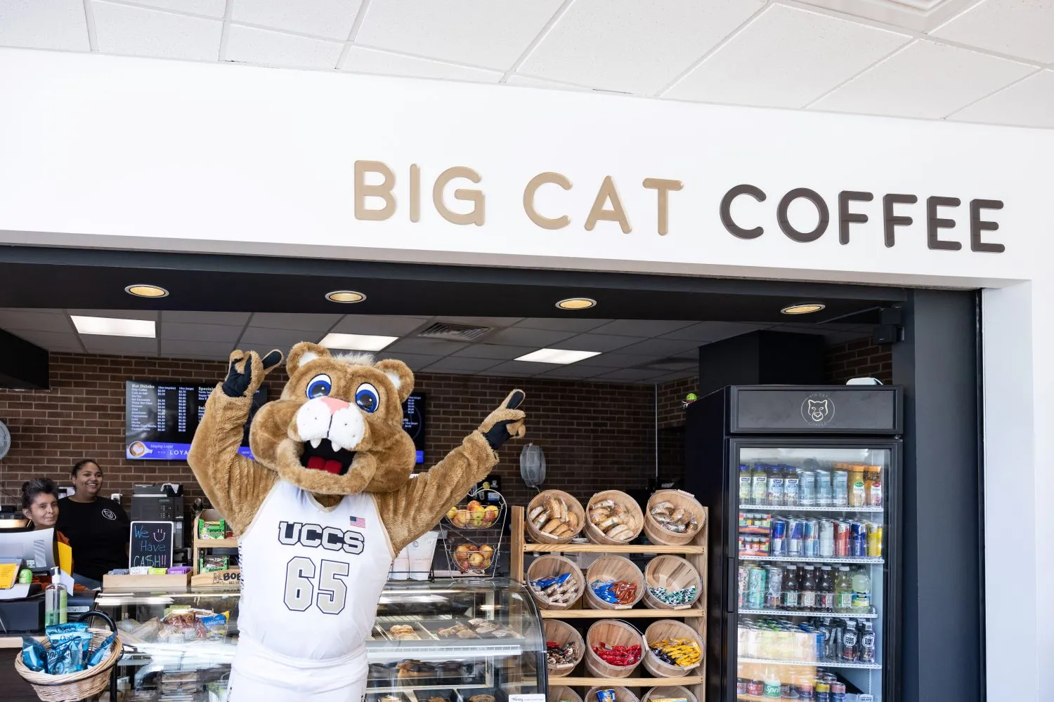 Clyde, the UCCS Mascot, point at the Big Cat coffee shop in the University Center