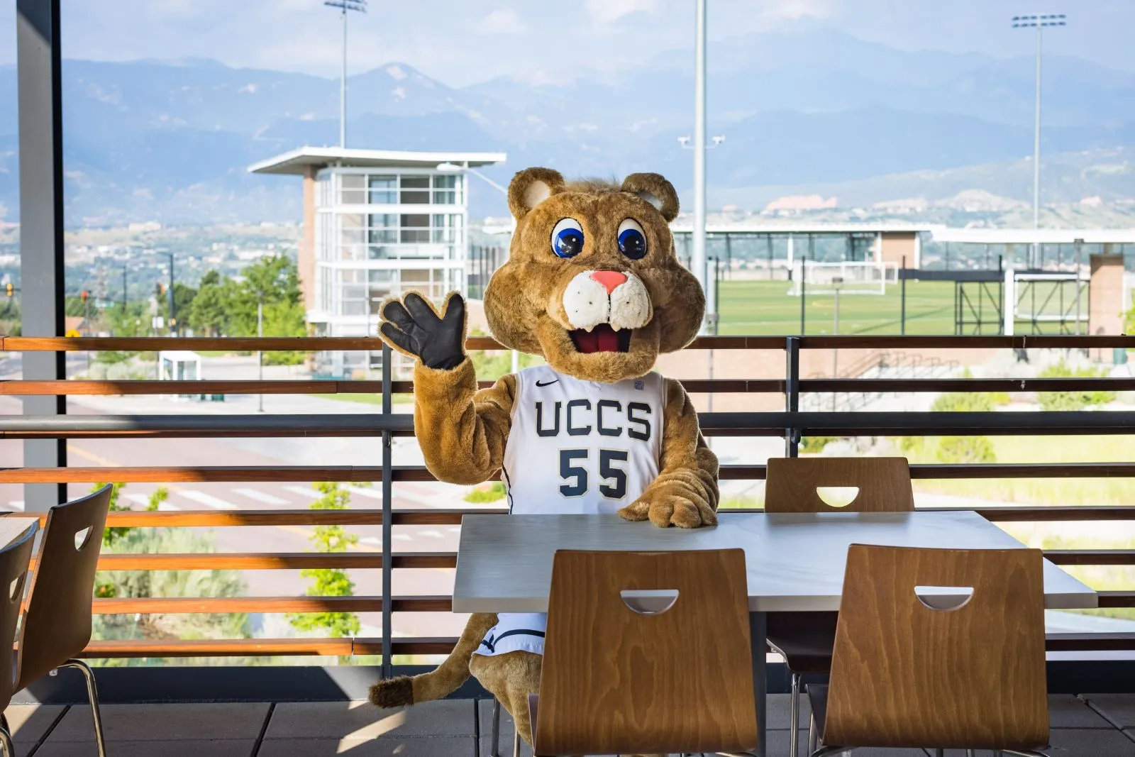 Clyde, the UCCS Mascot, sitting at a table in the Roaring Fork dining hall