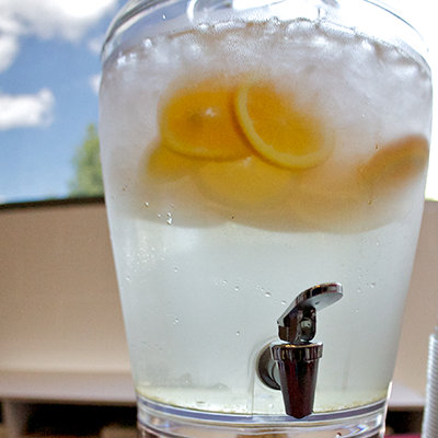 Water with citrus slices in a large serving container