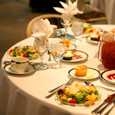 A picture of salad plates on a formally set table